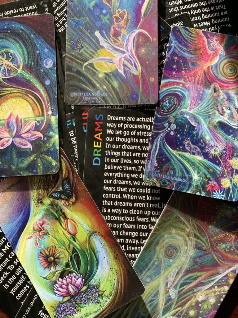 A vibrant collection of dream-themed tarot cards with swirling colors and mystical imagery.
