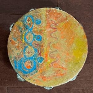 Colorful textured circular artwork with orange, yellow, and blue patterns.